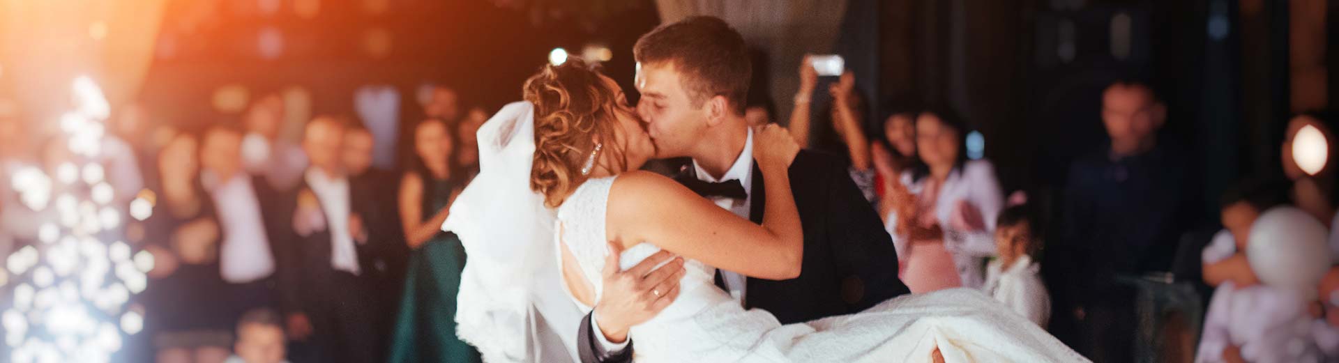 Bride and Groom share a passionate kiss on the dance floor